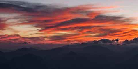 Fototapeta premium Red clouds in the sky at sunset
