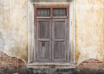 Fototapeta na wymiar Old wooden door in broken dirty wall. Loft abstract interior. Square background texture.