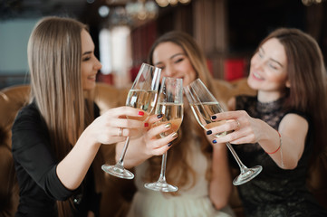 holidays, nightlife, bachelorette party and people concept - smiling women with champagne glasses