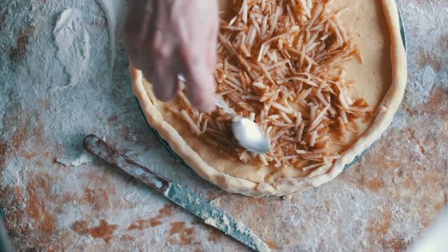 A woman is preparing an apple pie in a home kitchen,Fast shooting