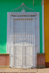 Typical colonial building with white  window iron grate, Cuba