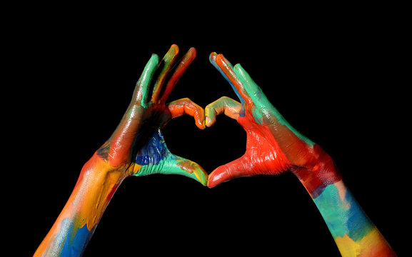 Colorful Painted Hands making heart shape love concept