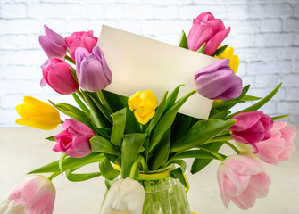 Beautiful festive bouquet of tulips on white background. Copy space.