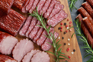 Set of cold cuts on a wooden board. Mix of sausages