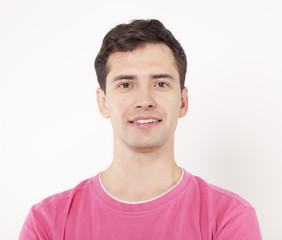 Smiling young man in pink shirt