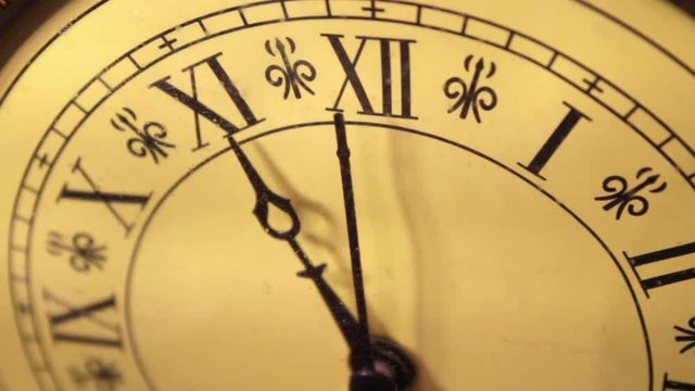 An old antique bronze clock ticks slowly by