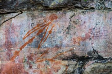 Aboriginal paintings on rock, Kakadu National Park, Northern Territory, Australia. The painting is a warning not to disturb a sacred site and threatens swollen joints