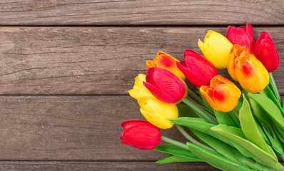 Colorful Spring Tulips on a Weathered Wooden Background