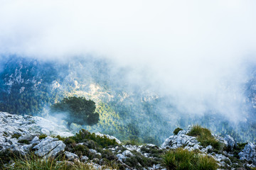 sun setting over the mountains on a cloudy day
