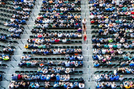People sitting in bleachers in a stadium from above