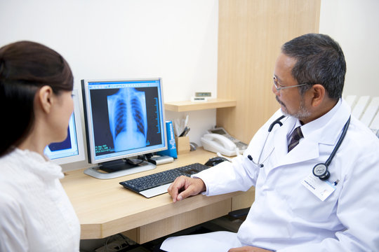 Doctor with patient looking at x-ray