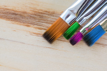 Fototapeta premium Art background. Brushes for painting on wooden canvas