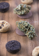 Cannabis nugs over infused chocolate chips cookies - medical marijuana edibles concept