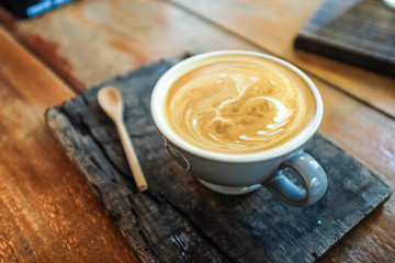 Latte art coffee on wood table