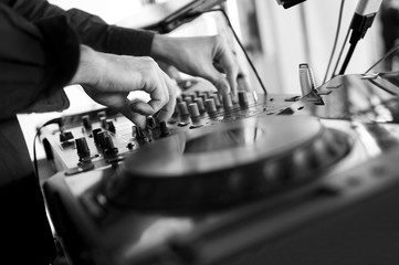 Dj mixes the track in the nightclub at party