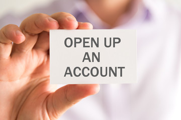 Businessman holding a card with OPEN UP AN ACCOUNT message