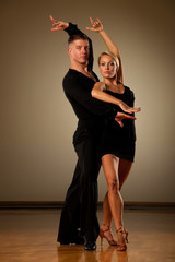 Beautiful ballroom couple preforming their pasonate exhibition dance