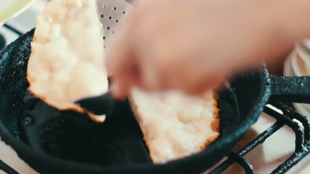 Housewife roasts chebureks in pan - Georgian national dish