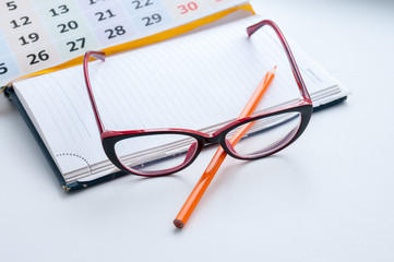 Business still-life, recording ideas, glasses, calendar and notes