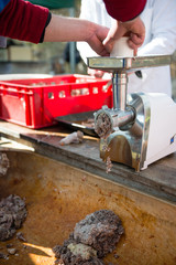 grinding pork meat for homemade sausages