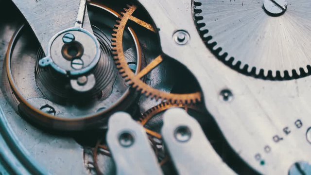 Old vintage clock mechanism working, closeup shot with soft focus