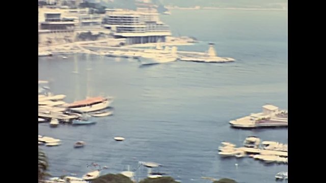 Aerial view on port Hercule in Monte Carlo and roads of the Grand Prix of Monaco, from Prince's Palace of Monaco overlook. Historic restored footage on 1960s in France.