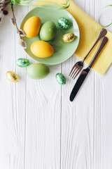 Easter concept. plate, fork, eggs on a white background