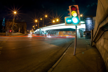 Naklejka na ściany i meble Urban city road with car light trails at night 