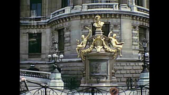 Touristic bus in Opera district looking the golden statues in front of the Opera Garnier palace in Paris. Today the golden color is gone. Historic restored footage from Paris, France on 1976 .