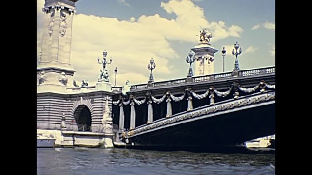 Paris touristic boat tour on Senna French river, with bridge Pont Alexandre III close up. Historic restored footage on 1976 in France.