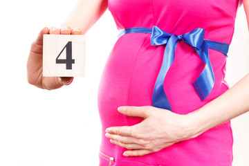 Hand of woman showing number of fourth month of pregnancy, expecting for newborn concept