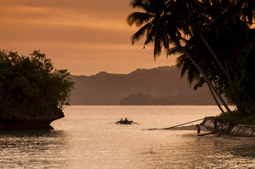 Naklejka premium Waigeo Island Indonesian Sunset. A colorful sunset in the Saporkren Village in the Raja Ampat area of West Papua, Indonesia.