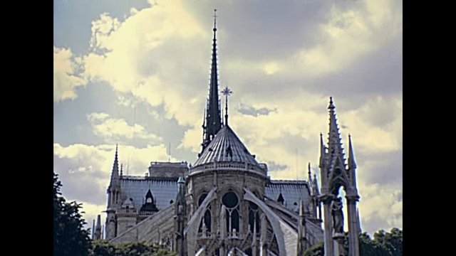Notre Dame Gothic cathedral in Paris, France with the spires on east side of the church. Historic restored footage on 1970s with no people. Details close up.Popular tourist attraction in Paris.