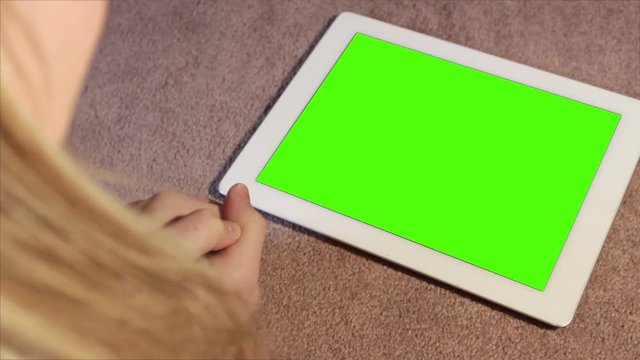 Woman watches and laughs at Green screen content on Generic Tablet 