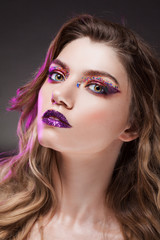 Fototapeta premium Young beautiful girl with creative make up. Attractive blonde, close-up