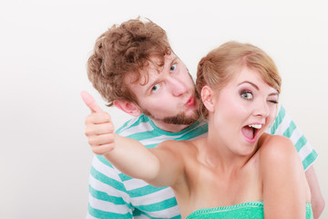 Loving couple girl holds thumb up gesture