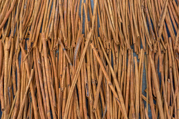 Fresh Cinnamon sticks out in the street drying in the midday sun. Viewed from above.