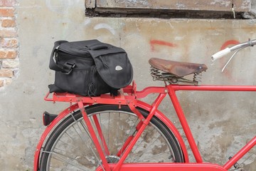Bag Black bicycle travel saddle Closeup, old brick wall background