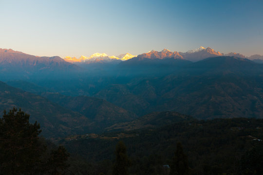 Morning Sun on Kangchenjunga Himalaya Mountain Peak with Valley Below