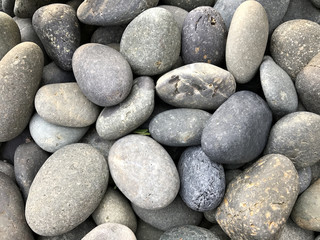 Fototapeta na wymiar Beautiful round stones on the beach near the sea