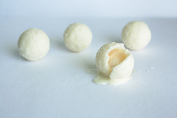 Fototapeta na wymiar white chocolate candy balls with coconut on white background