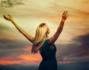 Beautiful woman standing with arms wide open