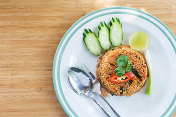 Spicy Fried rice on white dish on the wood table