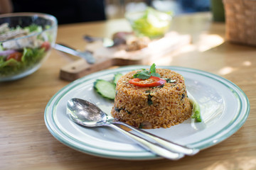 Spicy Fried rice on white dish on the wood table