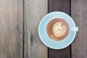 blue cup of hot coffee on wood background,over view