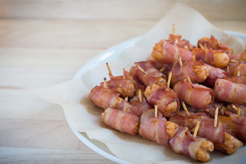Deep fried sausages rolled in bacon