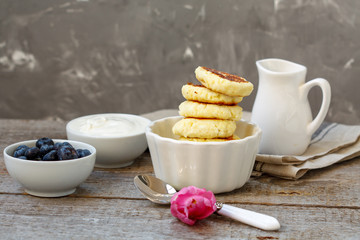 Cottage cheese pancakes for breakfast with blueberries and sour cream.