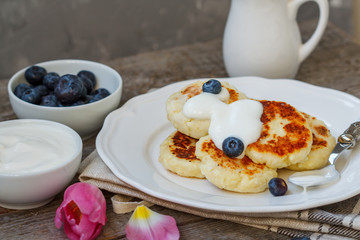 Cottage cheese pancakes for breakfast with blueberries and sour cream.
