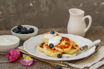 Cottage cheese pancakes for breakfast with blueberries and sour cream.