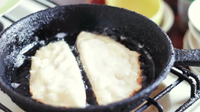 Pasties cheburek with meat fried in sunflower oil in frying pan